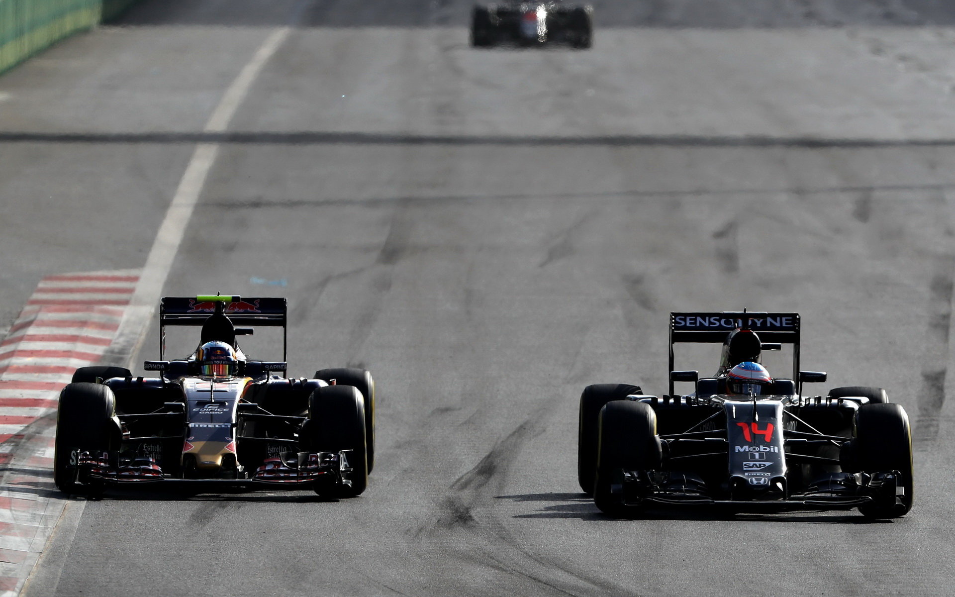 Fernando Alonso předjíždí Carlose Sainze v závodě v Baku