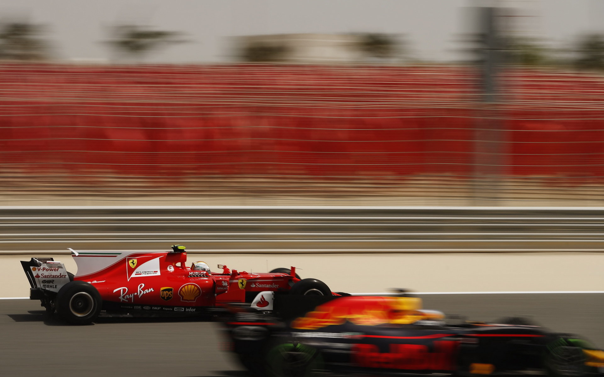 Sebastian Vettel předjíždí vůz Red Bull při sezónních testech v Bahrajnu