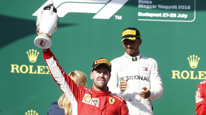 Sebastian Vettel se svou trofejí na pódiu po závodě v Maďarsku