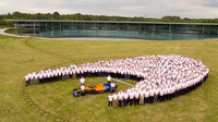 Skupinová fotografie McLarenu před jeho továrnou