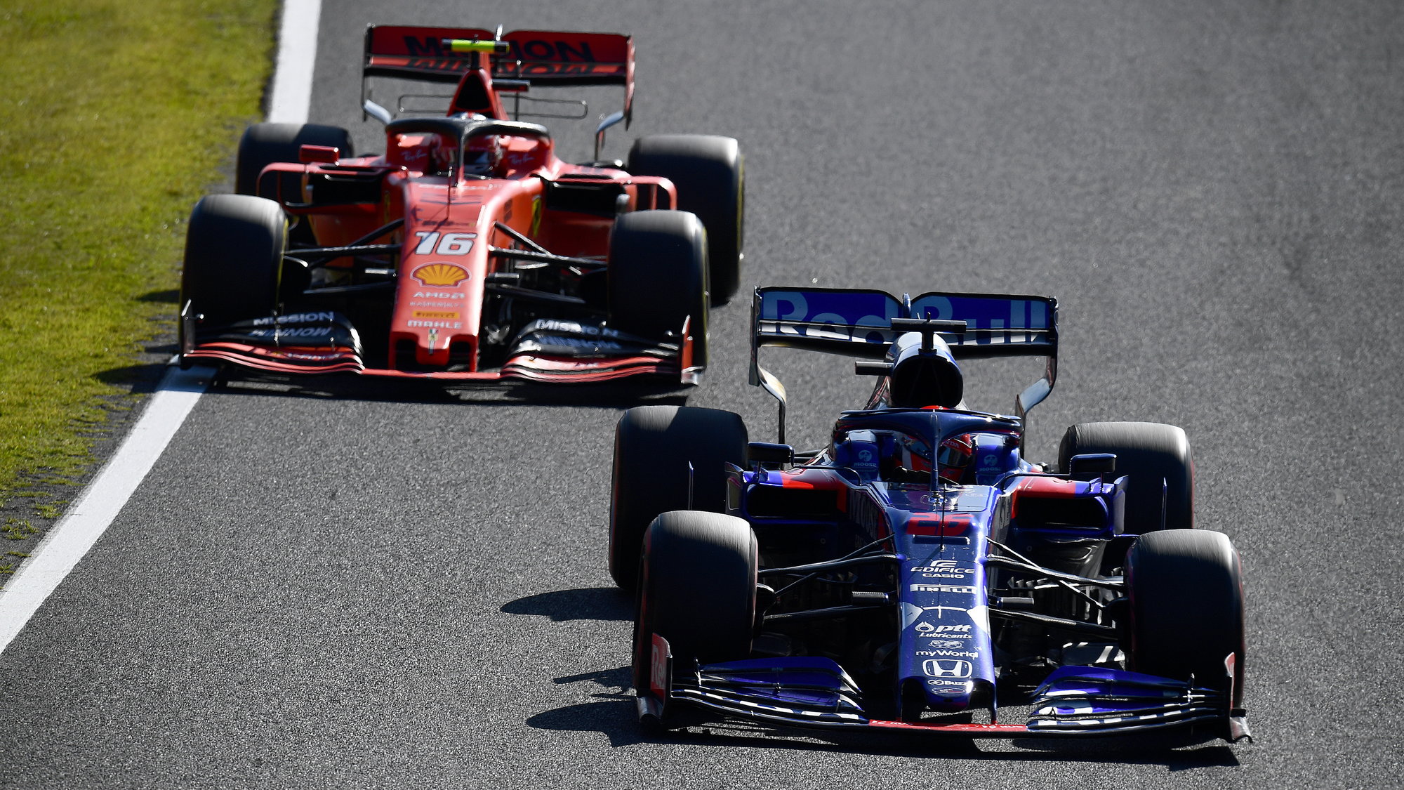 Daniil Kvjat s vozem Toro Rosso poháněným Hondou před rudým Ferrari Charlese Leclerca